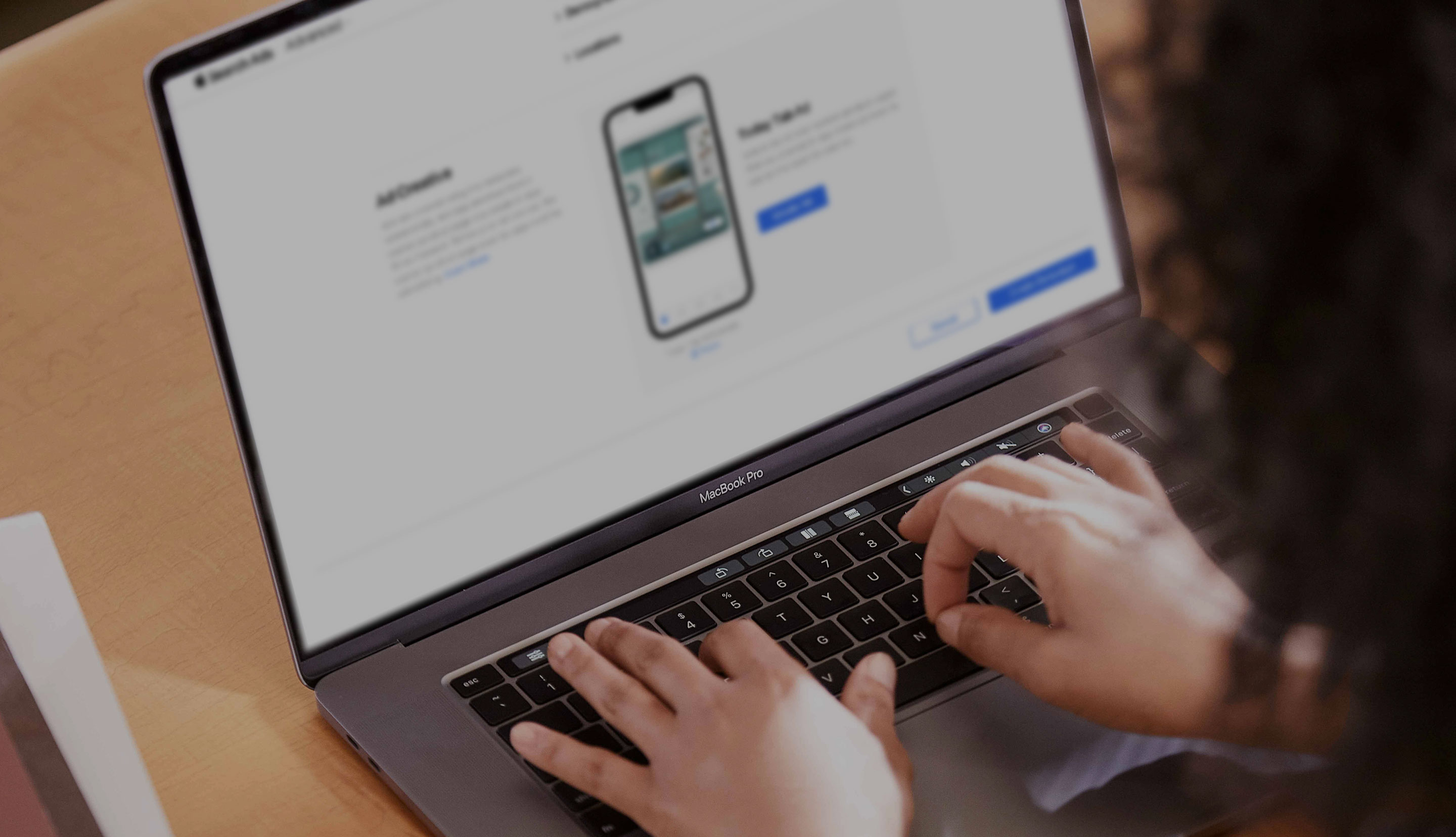 两只手在 MacBook 键盘上打字的特写。屏幕正在展示 Apple Search Ads 的界面，显示 Today 标签页广告系列的创建页面。